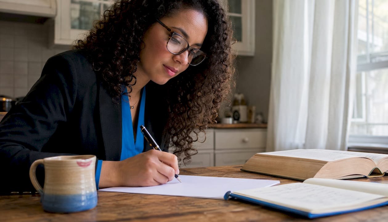 Solicitor drafting a will at desk