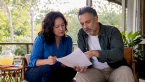 Couple reviewing legal documents on couch