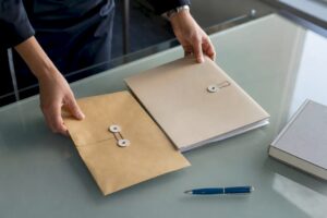 Hands placing sealed legal probate documents on desk